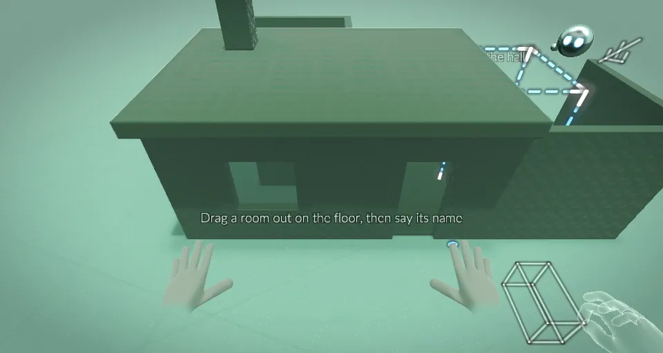 A simple dark green house blocked out on a pale green floor, with a dashed outline for the next room and two hands below. On-screen text reads: Drag a room out on the floor, then say its name.
